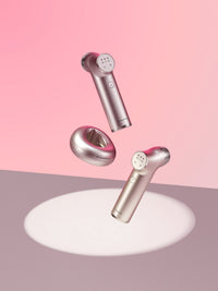 Minititan Charging Cradle floating with two Minititan devices over a spotlight on a pink backdrop (Minititan sold separately)